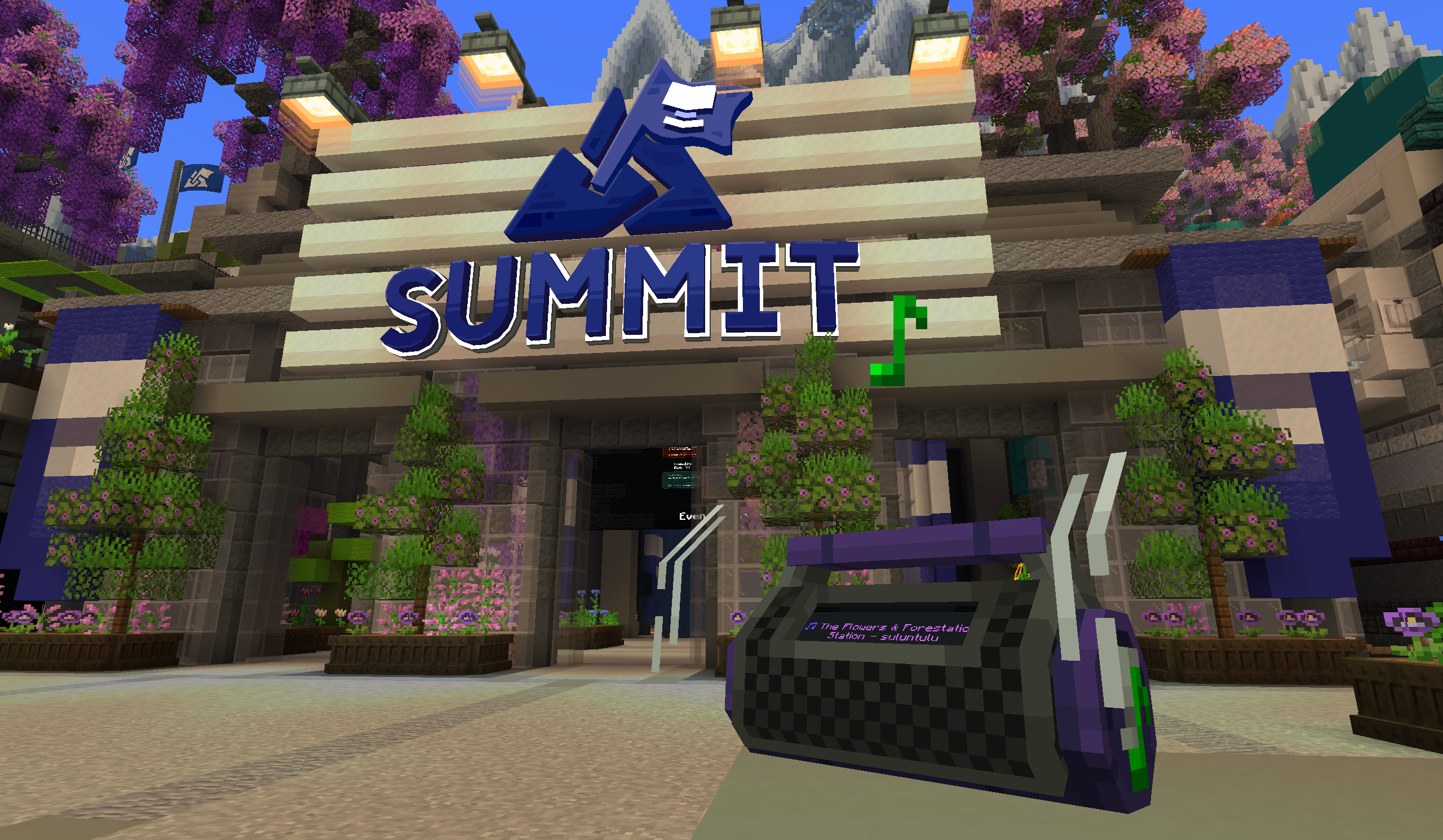 Bouncing music speaker in front of a Summit convention hall with a large SUMMIT sign.